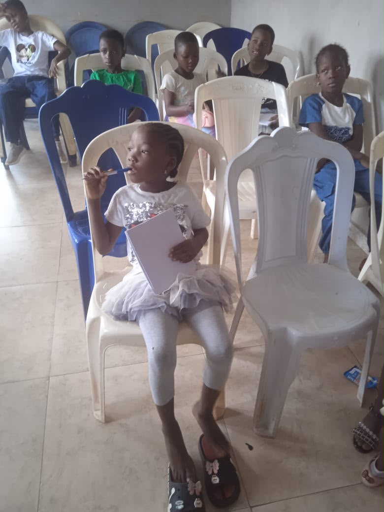 A girl seated in a hall during an event