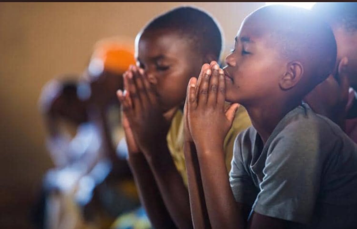 Two children praying together