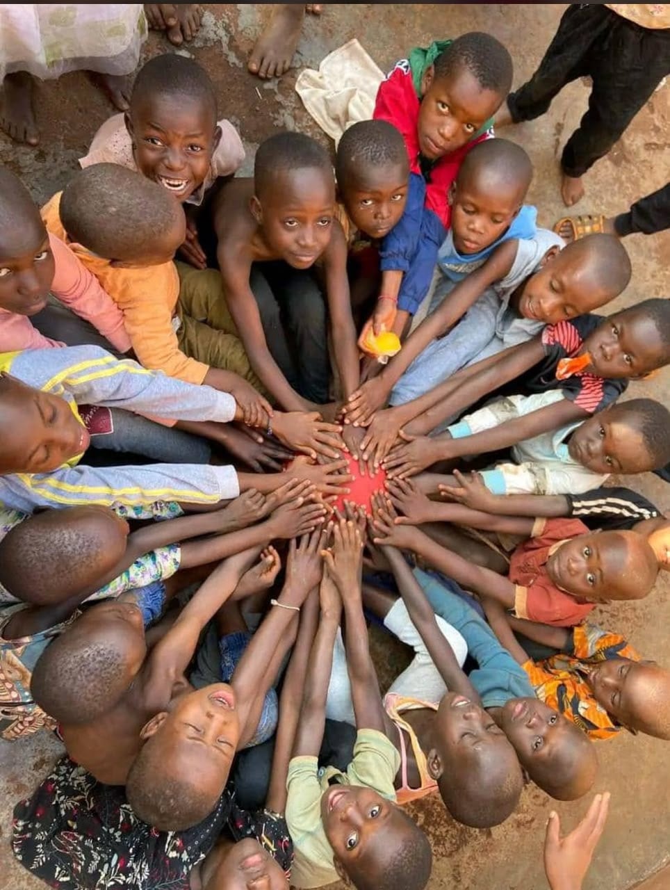 Children forming a circle with their hands joined at the centre