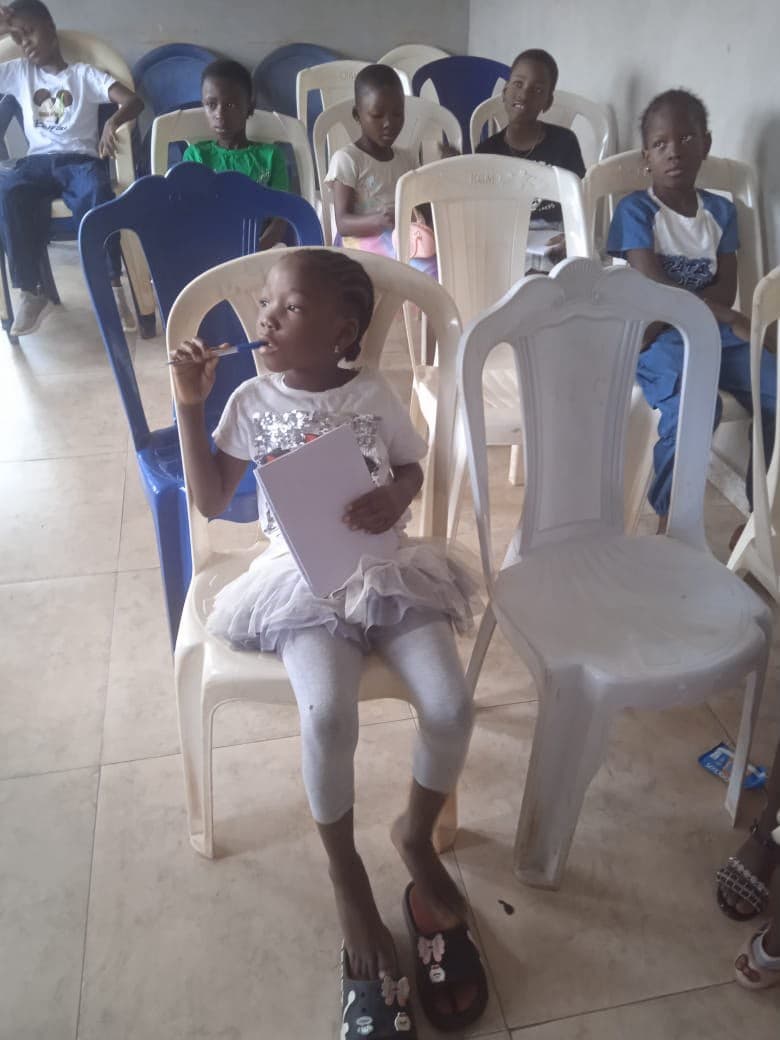 A girl seated in a hall during an event