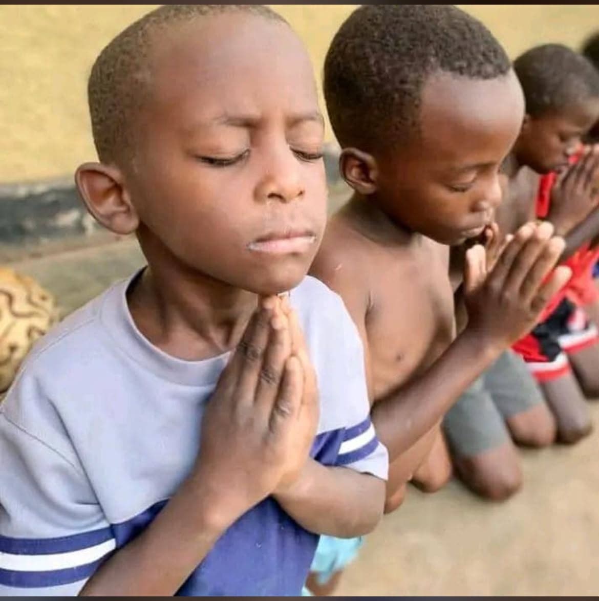 Two young boys praying