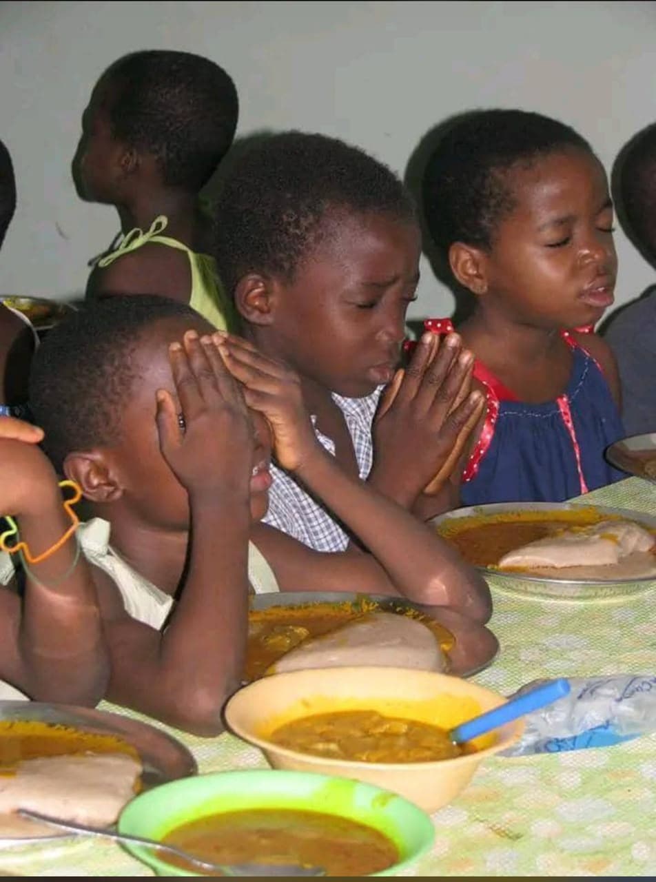 Children praying before a meal